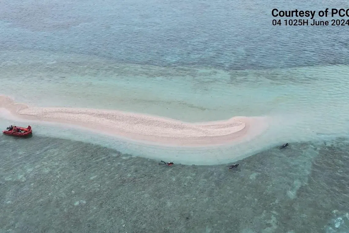 Philippine Coast Guard divers and marine scientists surveying part of Sabina shoal in the waters of South China Sea on June 7.