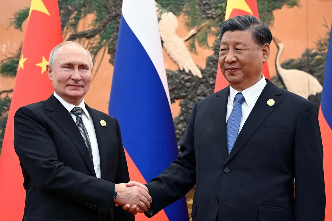 Russian President Vladimir Putin shaking hands with Chinese President Xi Jinping during a meeting at the Belt and Road Forum in Beijing, China on Oct 18, 2023. 