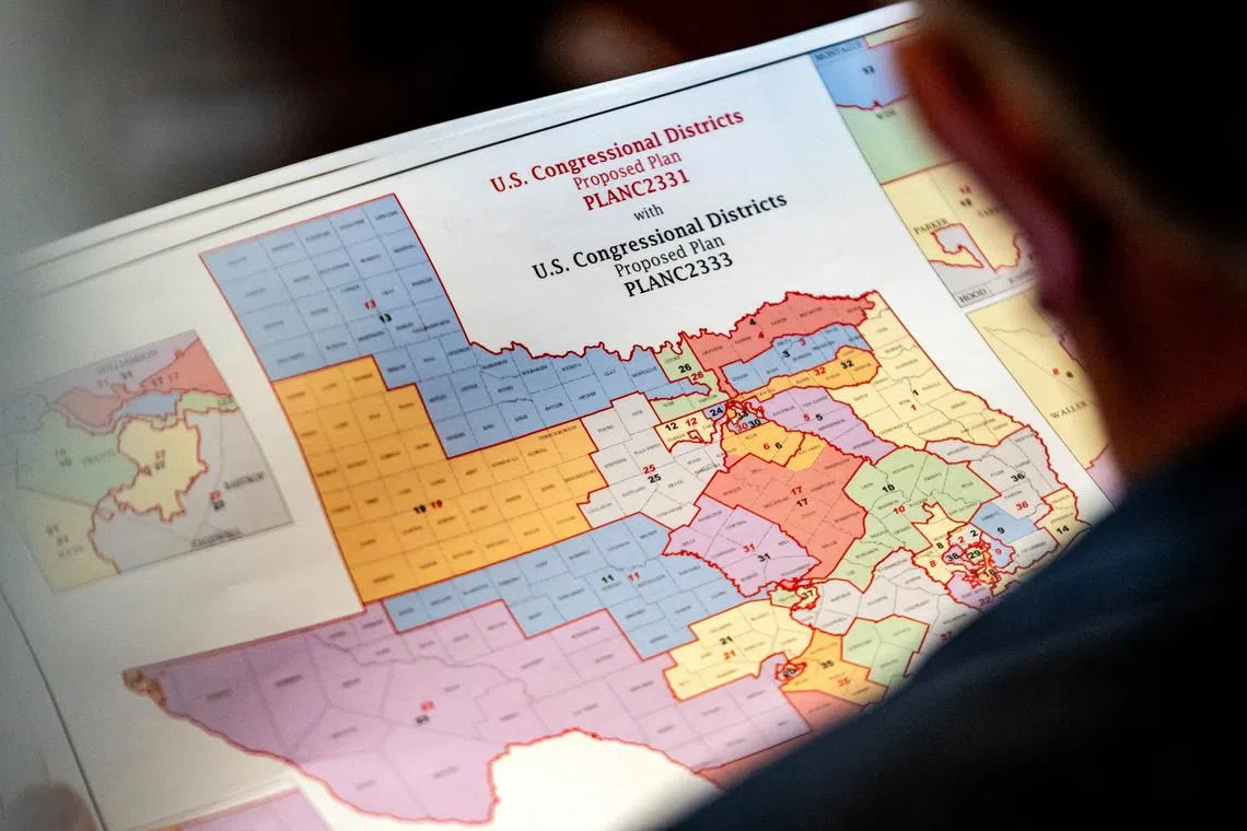 State Representative Matt Morgan (R-TX) holds a map of the new proposed congressional districts in Texas, during a legislative session as Democratic lawmakers, who left the state to deny Republicans the opportunity to redraw the state's 38 congressional districts, begin returning to the Texas State Capitol in Austin, Texas, U.S. August 20, 2025. REUTERS/Sergio Flores