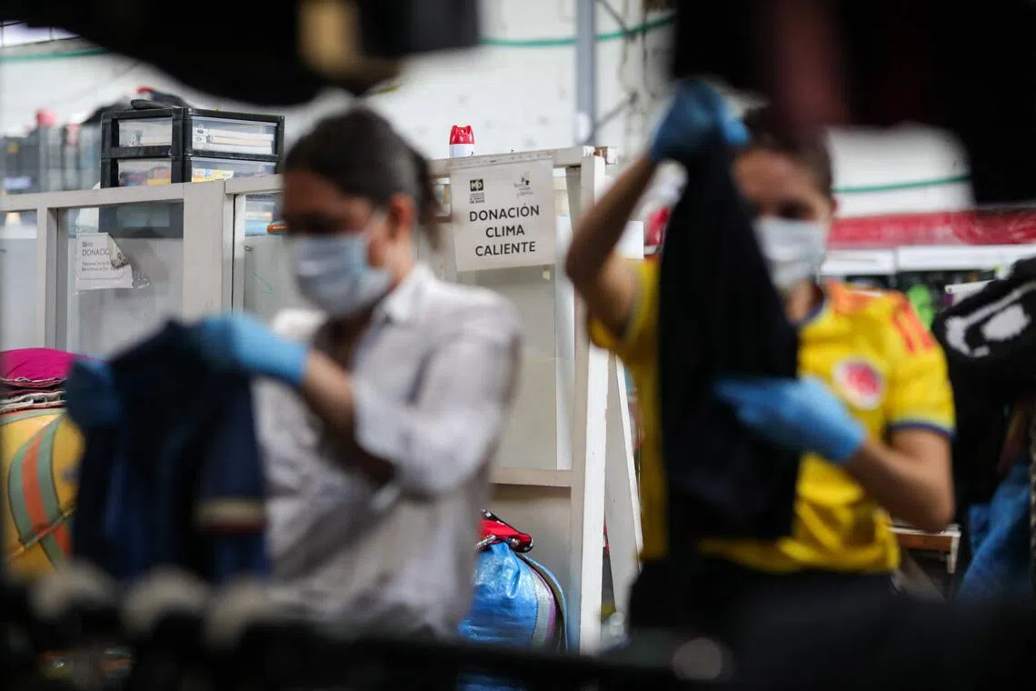 Volunteers gather clothing aid for earthquake victims in Bogota on Aug 11.