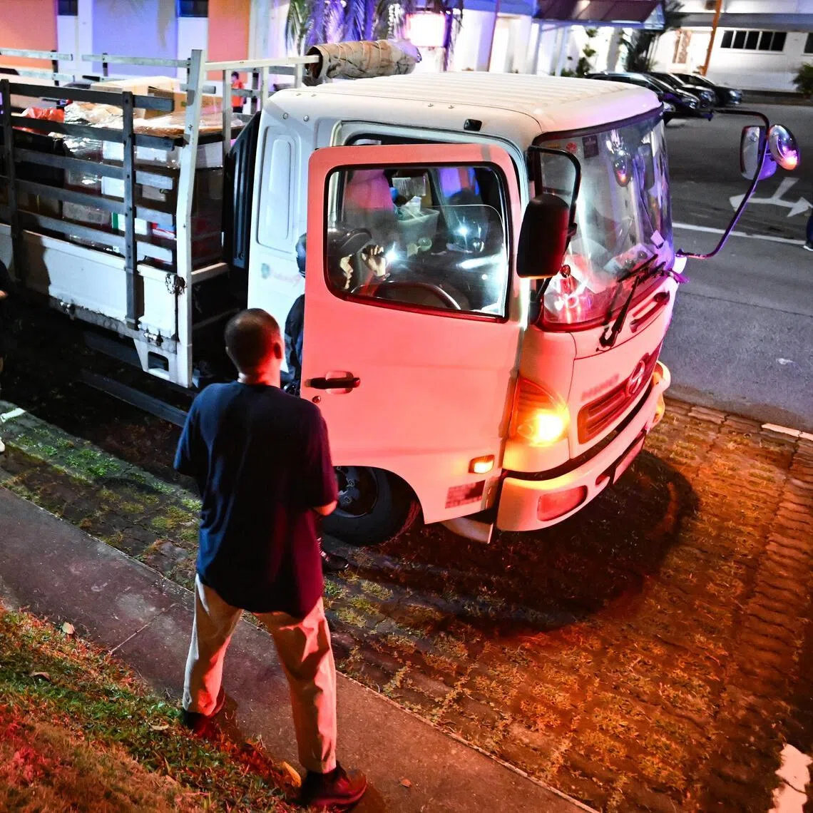 An officer from the Traffic Police Special Operations Team carrying out checks on a lorry during an enforcement operation in Hougang on Jan 16.