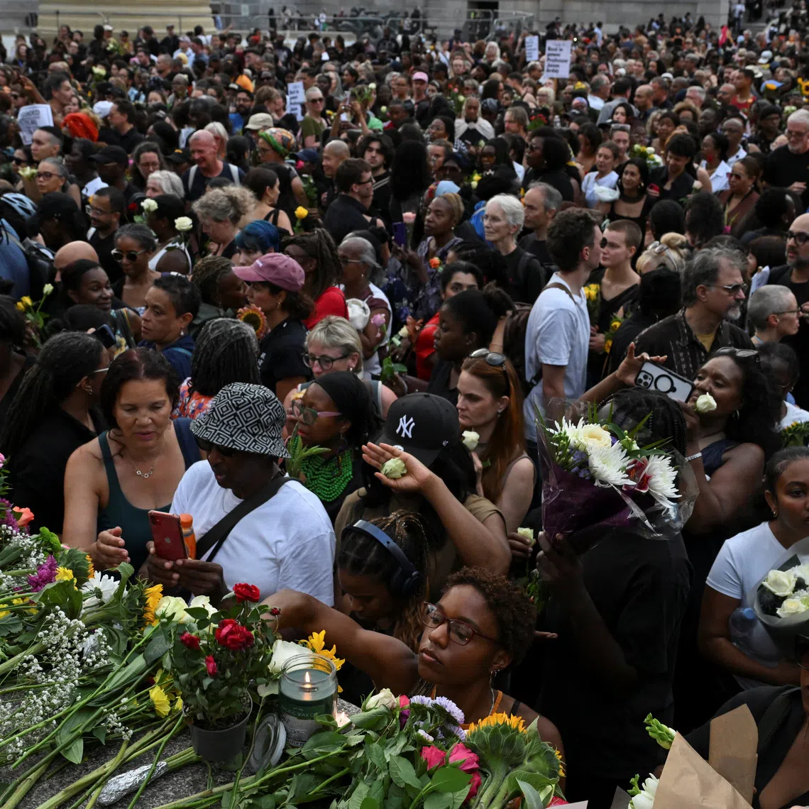 People lay flowers at Trafalgar Square in London during a vigil to remember former Cambridge professor Jason Arday, who died on Aug 14 after resigning amid plagiarism allegations which he denied.