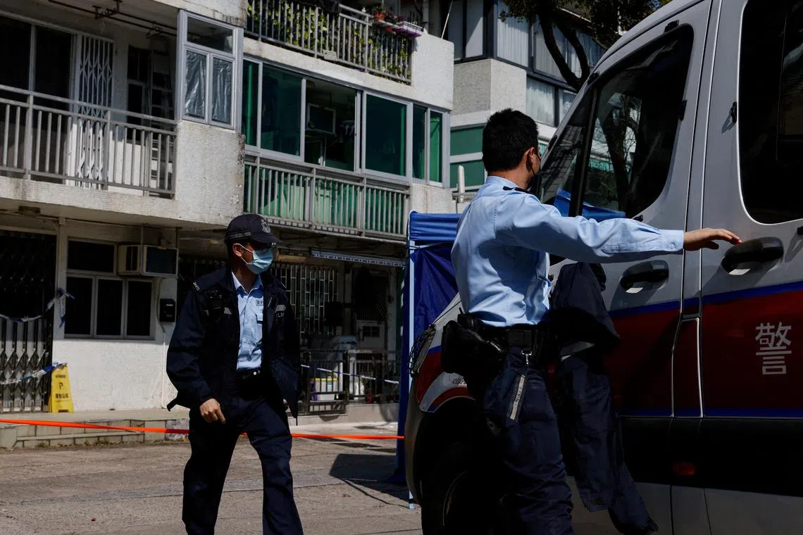 Police stand guard outside a village house where part of Abby Choi's body was found in Hong Kong. 