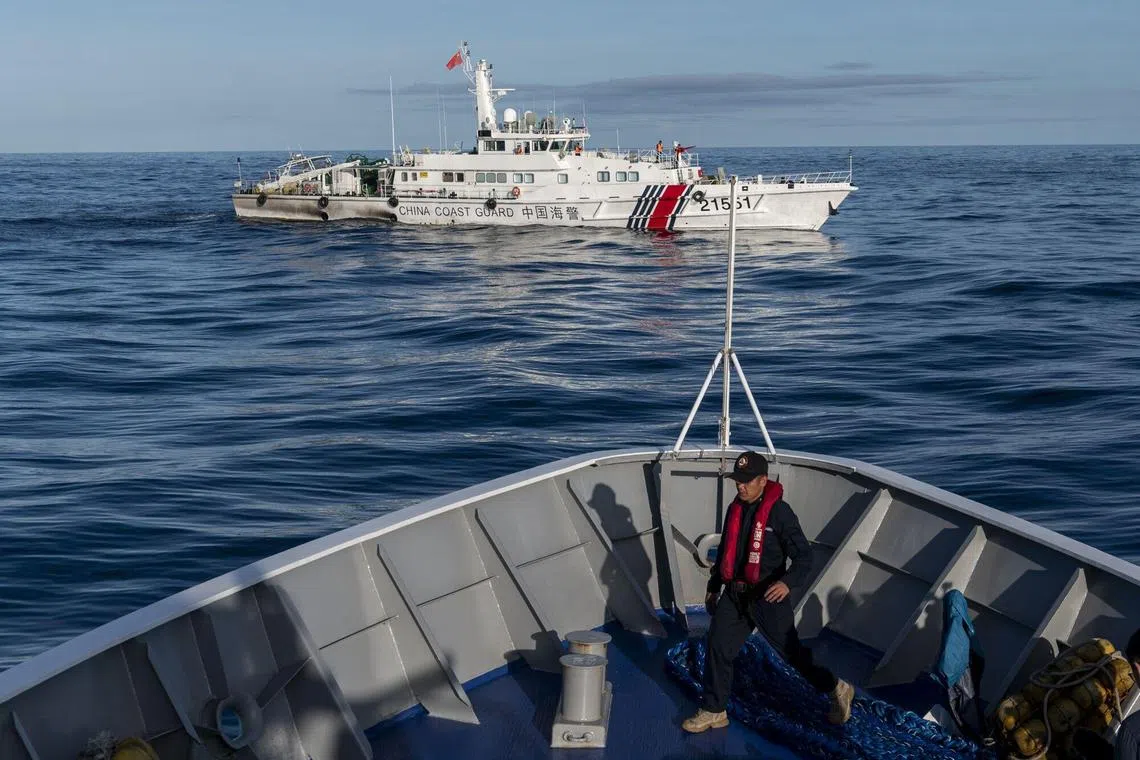 A China Coast Guard ship moving past a Philippine Coast Guard vessel in the South China Sea on Nov 10.