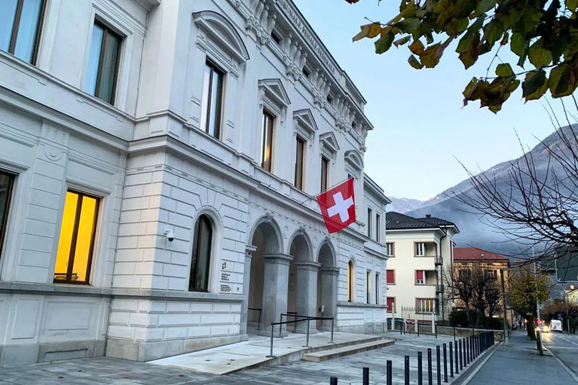 FILE PHOTO: Switzerland's national flag is displayed on the Swiss Federal Criminal Court (Bundesstrafgericht) building in Bellinzona, Switzerland, December 3, 2020. REUTERS/Emma Farge/File Photo