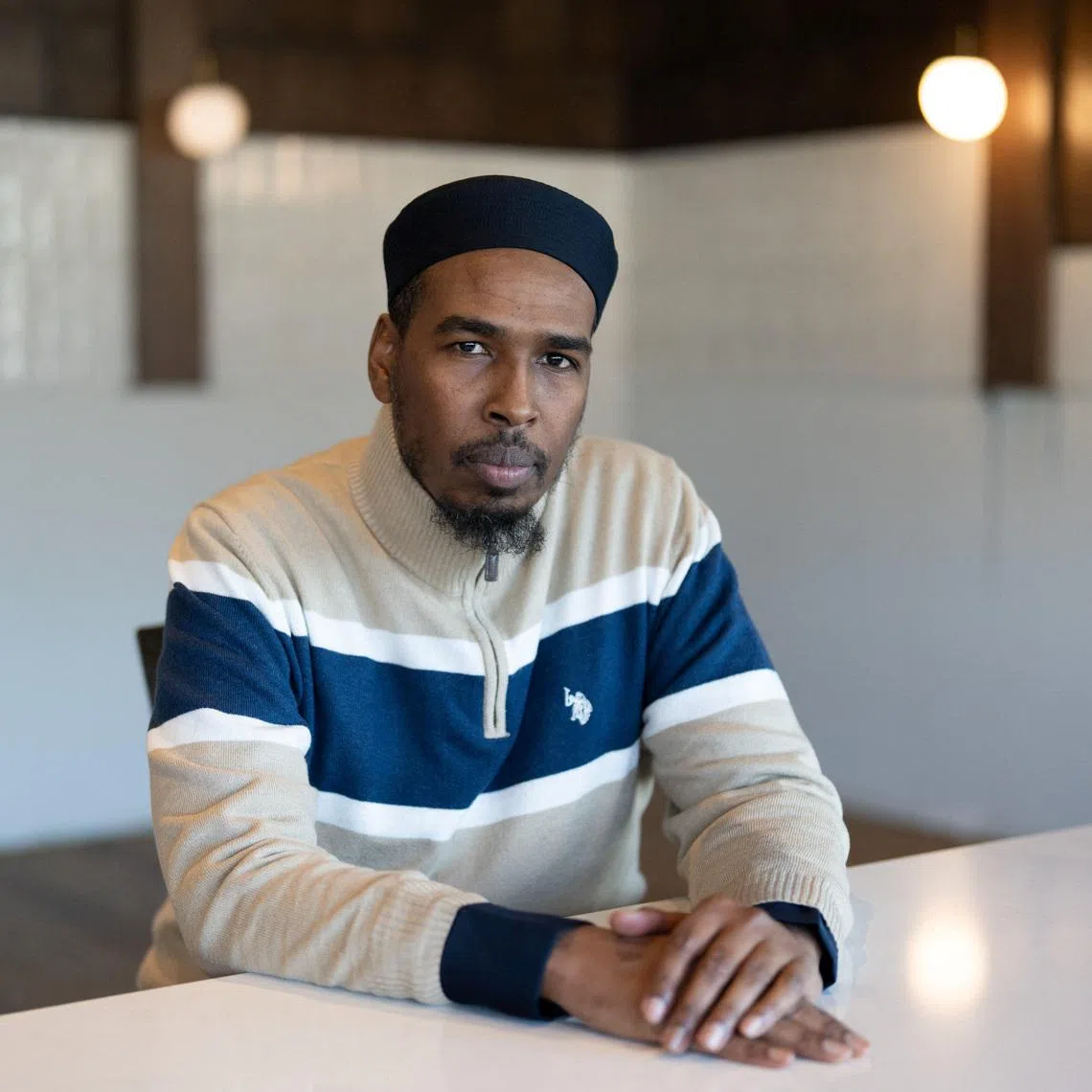 Abdulahi Farah, Chair of the Somali-American Leadership Table-MN (SALT) and a father leader, sits for a portrait, days after an ICE agent fatally shot Good, in Bloomington, Minnesota, U.S., January 14, 2026.   REUTERS/Tim Evans