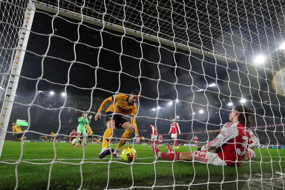 Arsenal's Riccardo Calafiori scores an own goal in the 94th minute, allowing Wolverhampton Wanderers to draw level.