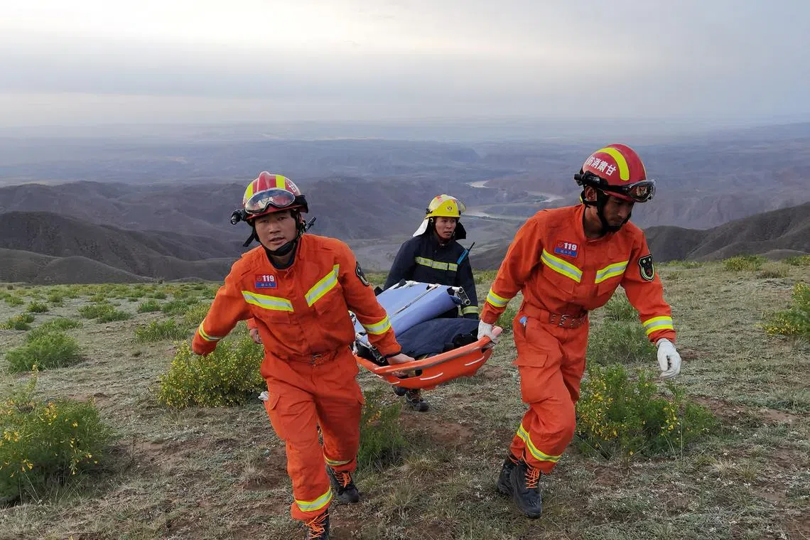 Rescue workers at the site where extreme cold weather killed participants of an 100-km ultramarathon race in 2021.