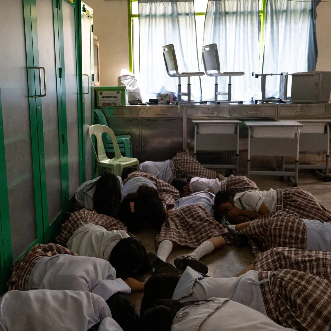 Students take cover during an active-shooter drill at Carlos F. Gonzales High School in San Rafael, Bulacan.