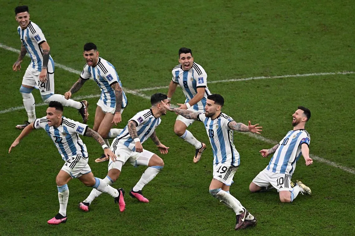 Argentina's players celebrate as Argentina's defender Gonzalo Montiel scores the winning goal during penalty shootout at the end of the Qatar 2022 World Cup final football match between Argentina and France.