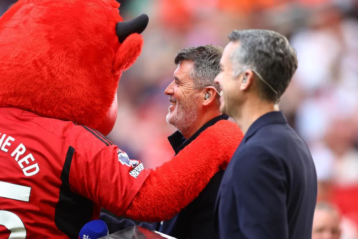 Former Manchester United player and TV pundit Roy Keane is pictured with the Red Devils' mascot Fred the Red before the Premier League match against Arsenal at Old Trafford on May 12, 2024.