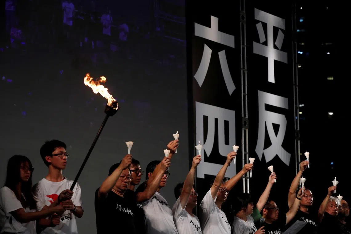 Activists attend a candlelight vigil to mark the anniversary of the Tiananmen crackdown, at Victoria Park in Hong Kong, on June 4, 2019.