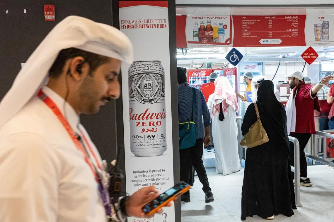 A Budweiser Zero beer advertisement is pictured as customers wait at a food stand during the World Cup opening game between Qatar and Ecuador at the Al Bayt Stadium in Al Khor on Sunday.