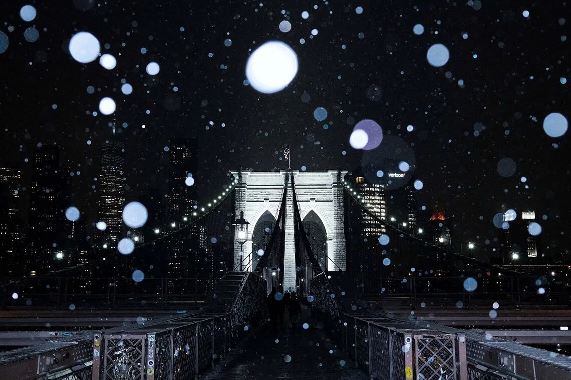 Snow falling on the Brooklyn Bridge during a winter storm in New York City, US, Dec 26, 2025. 