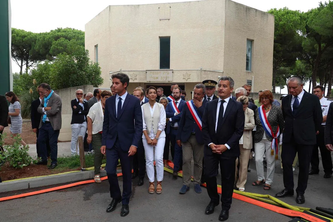 France's Prime Minister, Gabriel Attal (left) and France's Minister for the Interior and Overseas, Gerald Darmanin (right) flanked by France's Secretary of State for Citizenship Sabrina Agresti-Roubache (centre) exit the synagogue which was set on fire in La Grande-Motte, south of France, on Aug 24. 
