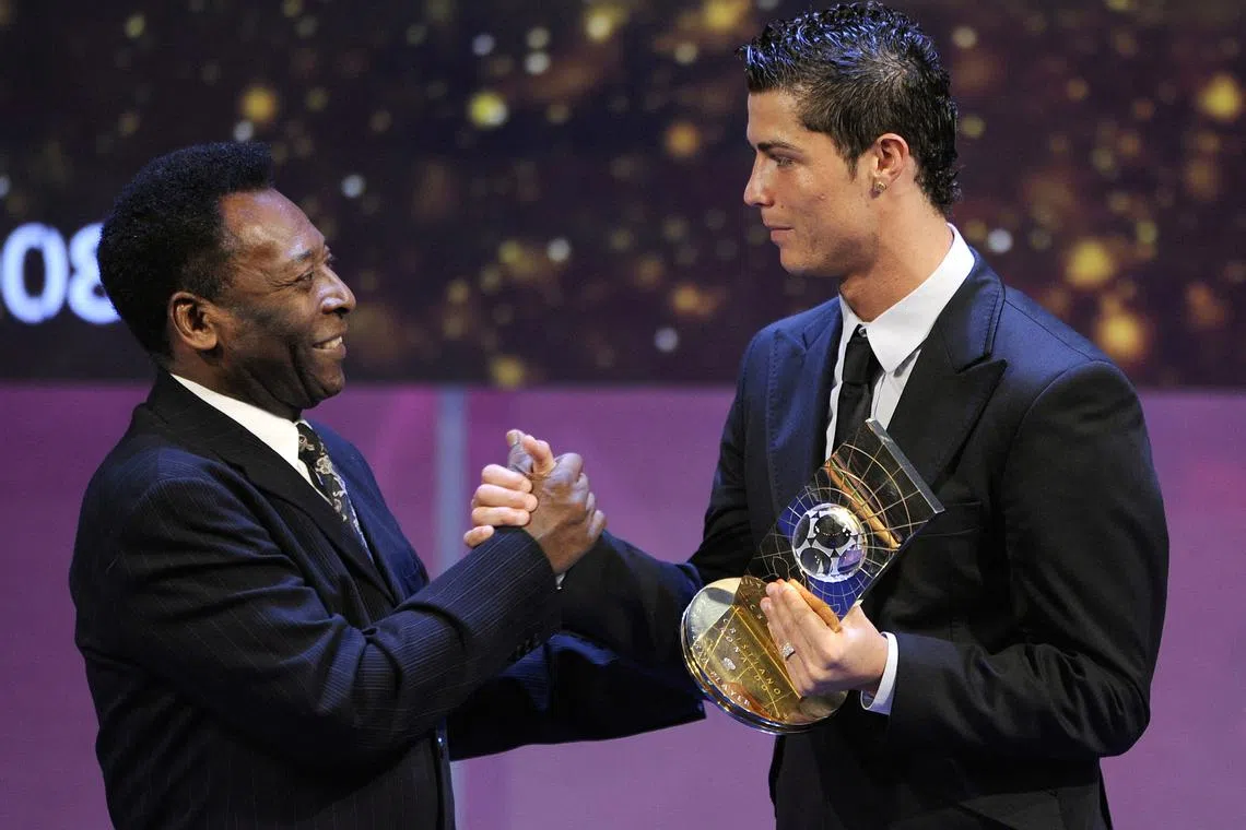 In this file photo taken on January 12, 2009 Portuguese football player Cristiano Ronaldo (R) receives congratulations from Brazilian football legend Pele after recieving the FIFA world footballer of the year 2008 award in Zurich. 