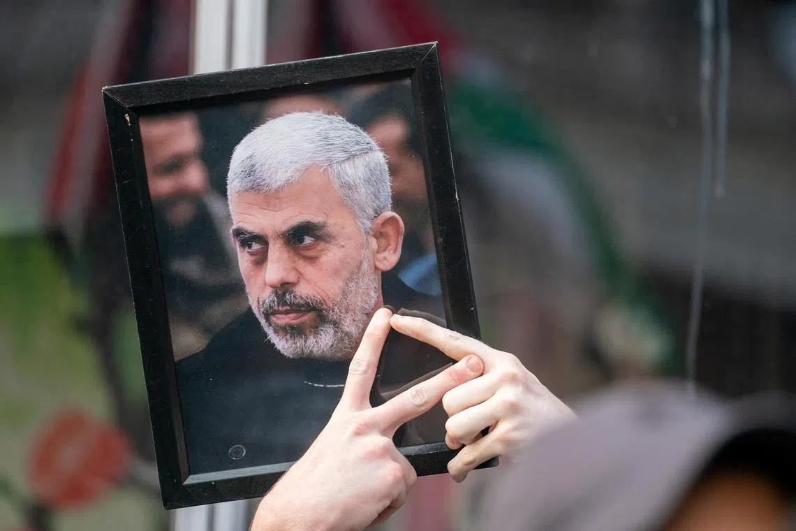 A pro-Palestinian protester holds up a portrait of Hamas leader Yahya Sinwar outside of a campaign event for Democratic presidential candidate and U.S. Vice President Kamala Harris in New York City, U.S., August 14, 2024. REUTERS/David 'Dee' Delgado