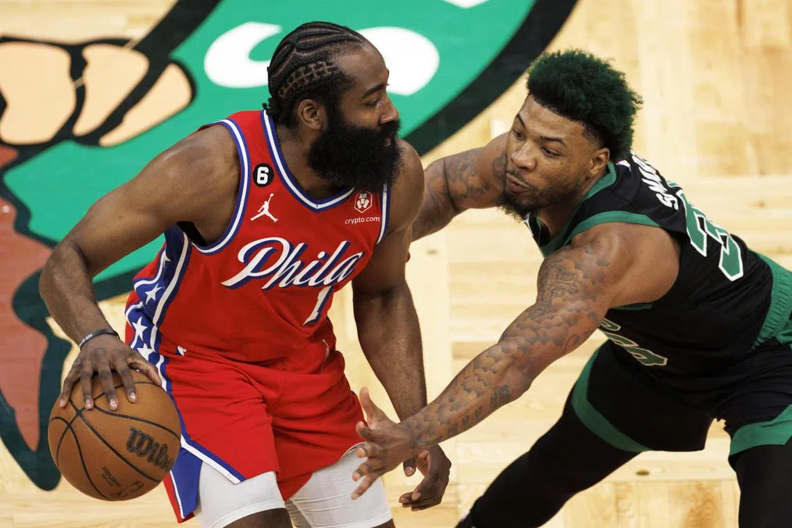 Boston Celtics' Marcus Smart reaching for the ball as Philadelphia 76ers guard James Harden brings the ball up court during the Eastern Conference semi-finals play-off game one in Boston.