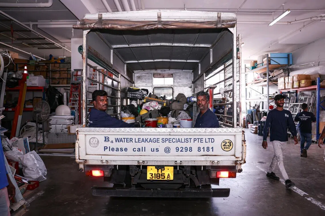 Workers aboard the lorry outside B4 Leakage Specialist in First Centre on March 20, 2026. ST PHOTO: BRIAN TEO