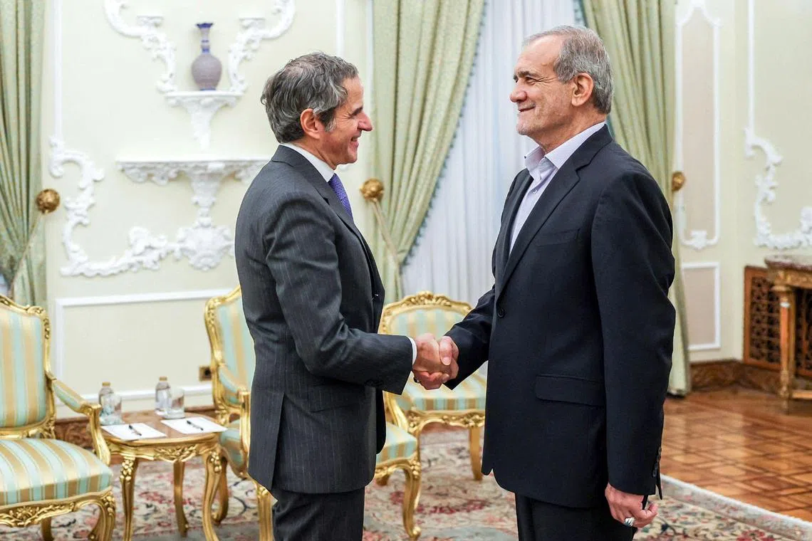 International Atomic Energy Agency chief Rafael Grossi (left) is welcomed in Iran by  Iranian President Masoud Pezeshkian, on Nov 14.