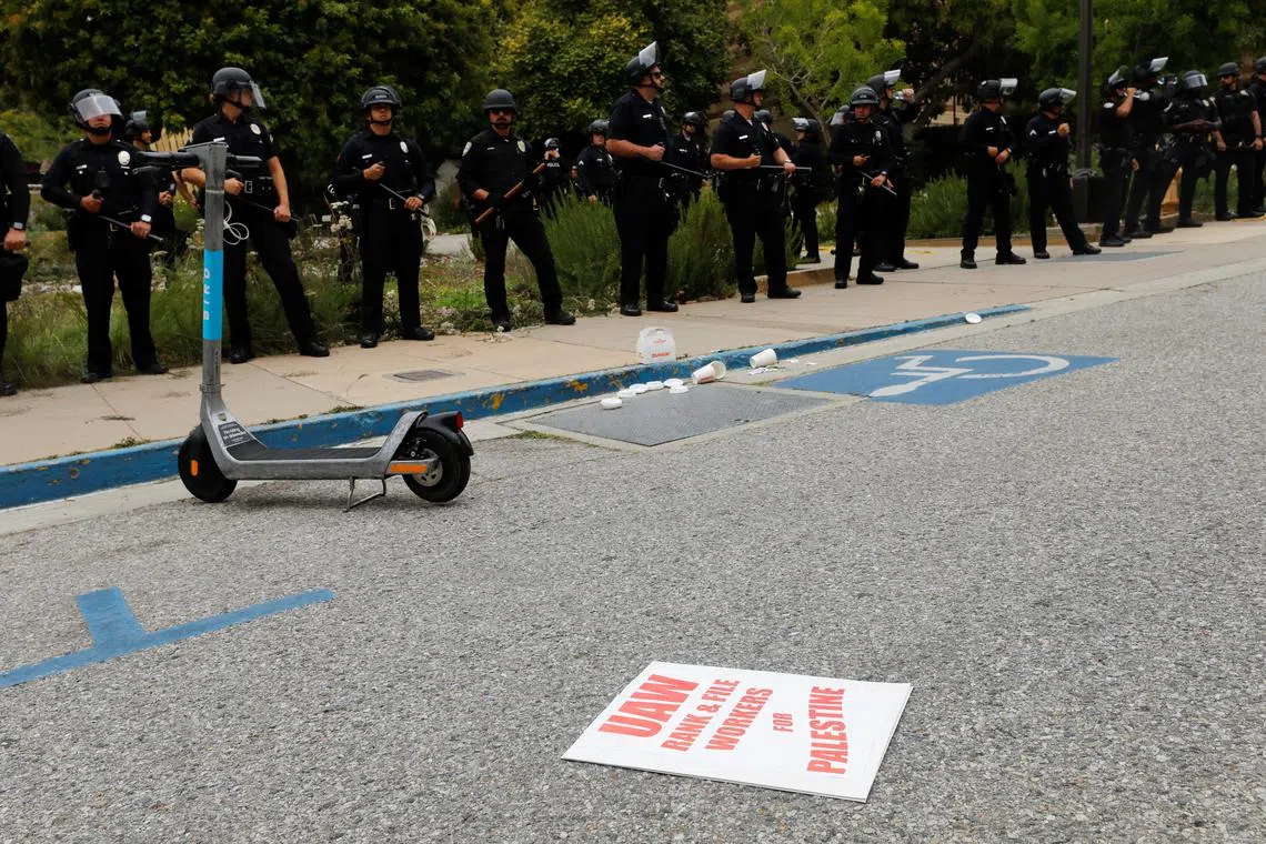 Police officers stand guard, on the day pro-Palestinian activists' set up an encampment, at the University of California, Los Angeles (UCLA), amid the ongoing conflict between Israel and Palestinian Islamist group Hamas, in Los Angeles, California, U.S., May 23, 2024. REUTERS/Carlin Stiehl/ File Photo