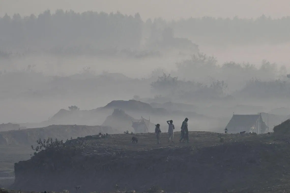 Children play amid heavy smog conditions in Lahore on Dec 7, 2022.