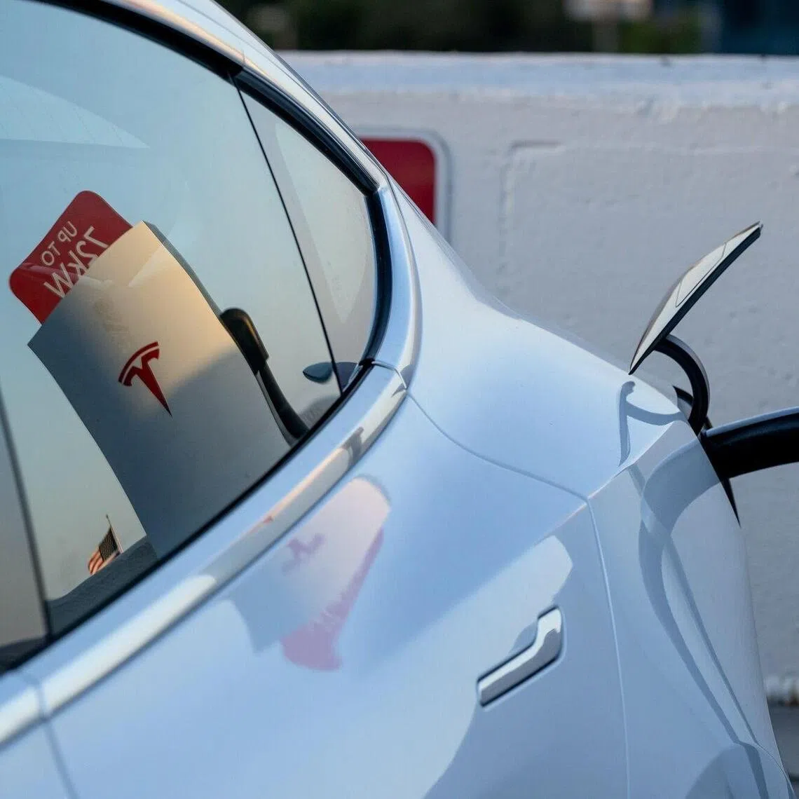 A Tesla Inc. electric vehicle (EV) at a SuperCharger station in San Francisco, California, US, on Friday, Jan. 23, 2026. Tesla Inc. is scheduled to release earnings figures on January 28. Photographer: David Paul Morris/Bloomberg