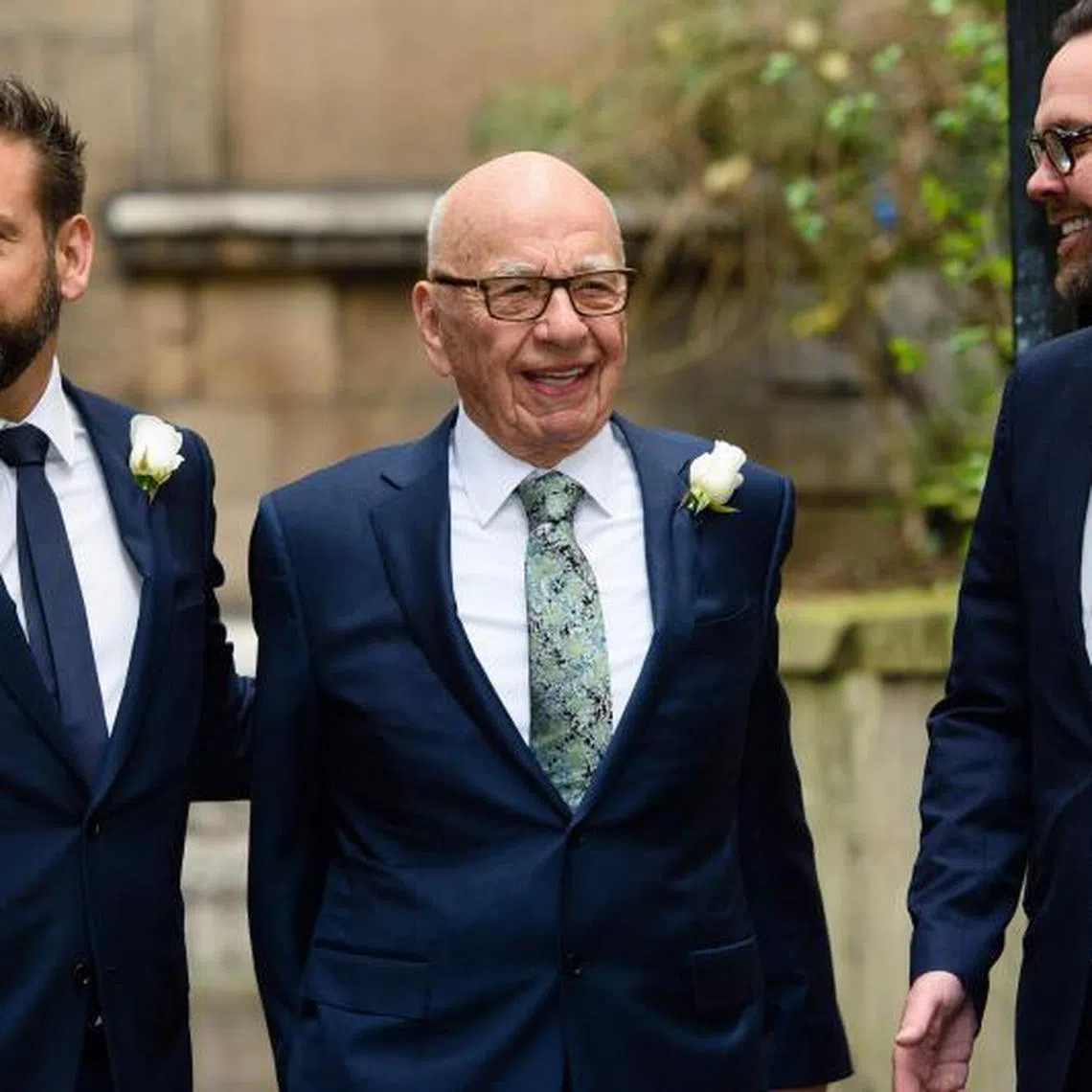Mr Rupert Murdoch (centre) flanked by his sons Lachlan (left) and James (right) at St Bride's church in central London.