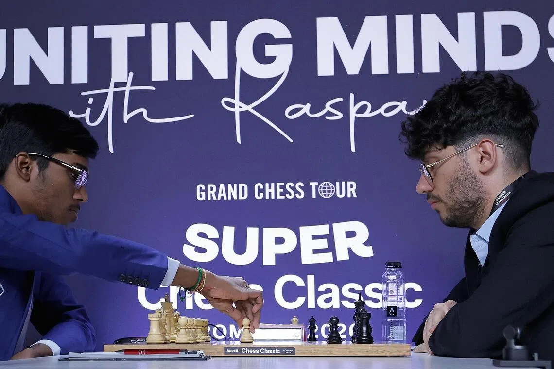Indian chess grandchess Rameshbabu Praggnanandhaa (left), the world defending champion, makes the first move with the white pieces against Iranian-French chess grandmaster Alireza Firouzja on the first competion day for the 1-st stage of Grand Chess Tour - 'Super Chess Classic Romania 2026' - held at the National Bank of Romania Palace in Bucharest, Romania on May 14, 2026.