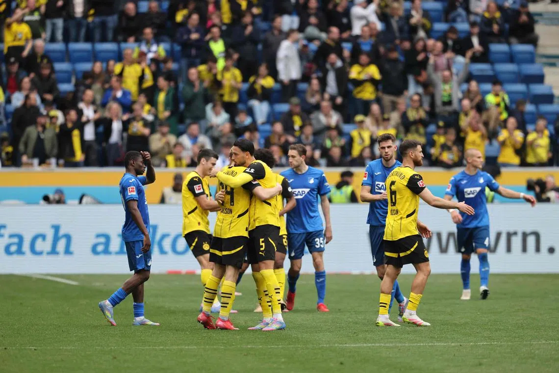 Dortmund players celebrate after beating Hoffenheim 3-2 in their Bundesliga match in Sinsheim on April 26, 2025.