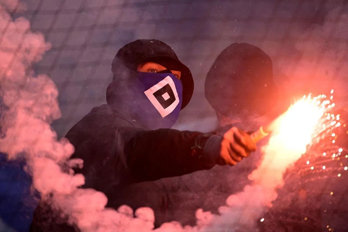 Soccer Football - Bundesliga - Werder Bremen v Hamburg SV - Weserstadion, Bremen, Germany - April 18, 2026 A Hamburg SV fan holds a flare in the stands during the match REUTERS/Fabian Bimmer