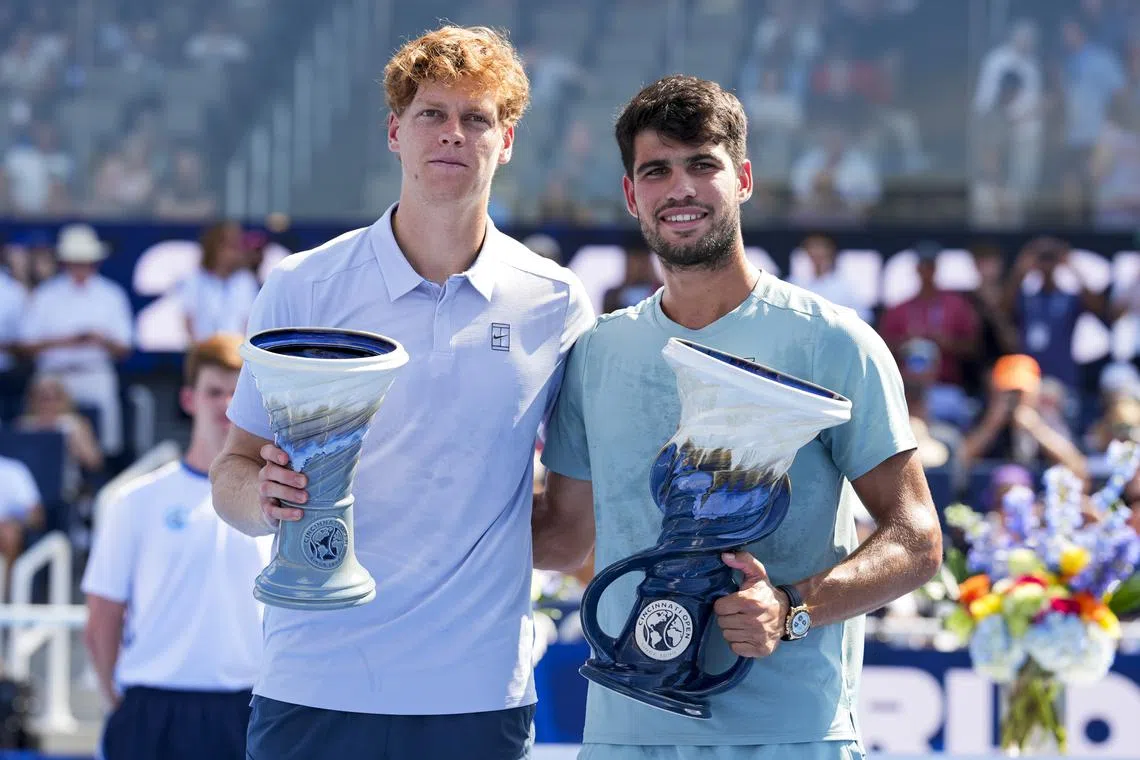 Aug 18, 2025; Cincinnati, OH, USA;  Jannik Sinner (ITA) and Carlos Alcaraz (ESP) pose for a photo after their match during the Cincinnati Open at the Lindner Family Tennis Center. Mandatory Credit: Aaron Doster-Imagn Images