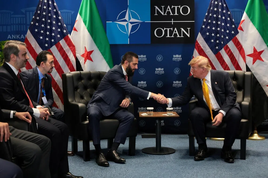 US President Donald Trump (right) shaking hands with Syrian President Ahmed al-Sharaa at a NATO leaders summit in Ankara, Turkey, on July 8.