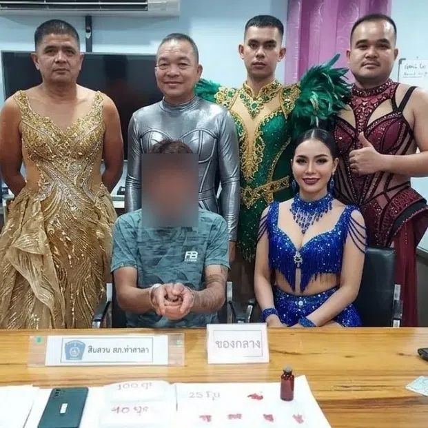 This photo of six officers shown in the dancer costumes while flanking a suspect became a viral sensation.