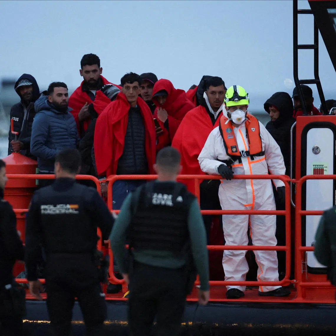 Migrants wait to disembark from a Spanish Coast Guard vessel after authorities said they rescued people off the Balearic island of Ibiza, as it docks at the port of Ibiza, Spain, February 27, 2026. REUTERS/Francisco Ubilla
