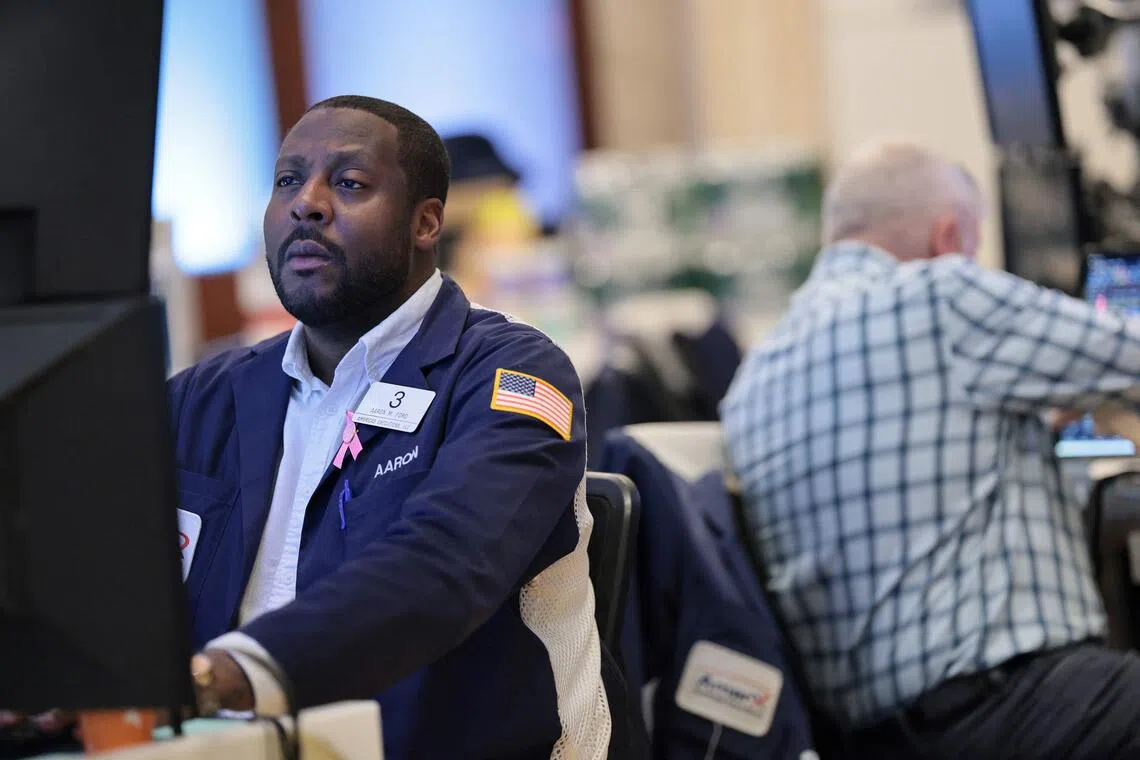 Traders working on the floor of the New York Stock Exchange during morning trading, on Oct 21, in New York City.