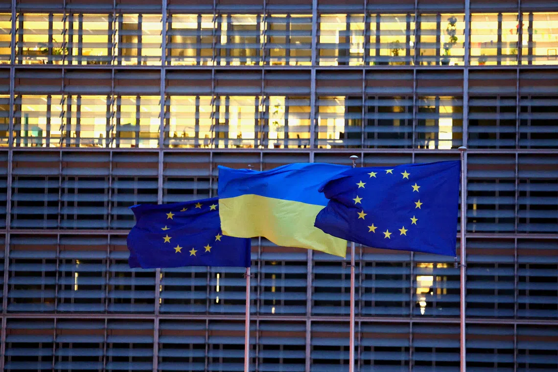 European Union flags and a Ukrainian flag flutter outside the EU Commission headquarters in Brussels, Belgium, February 24, 2025. REUTERS/Yves Herman