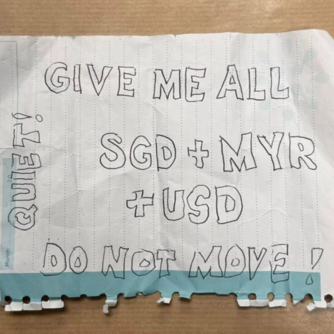 The suspect had shown the victim a handwritten note demanding money. 