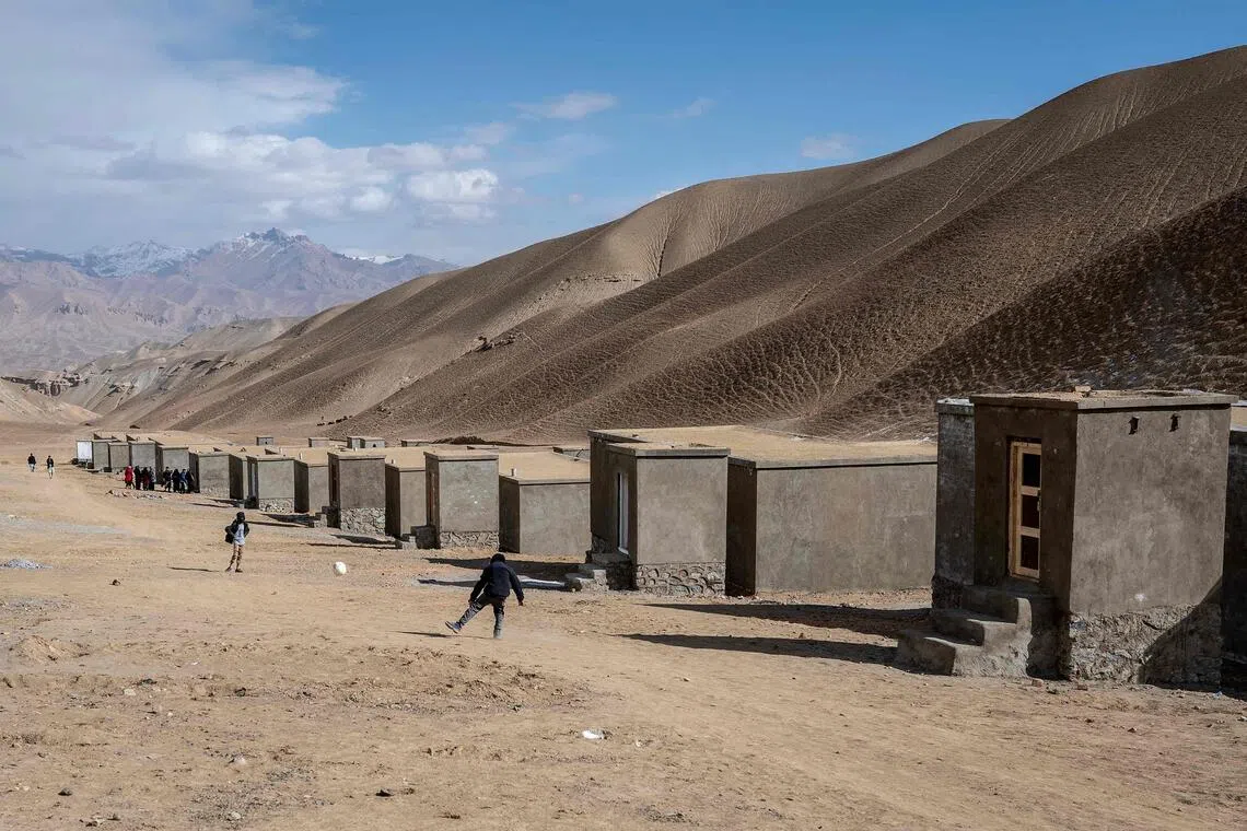 Children playing football near the newly constructed houses for Afghan returnees from Iran and Pakistan in Jar-e-Khushk on the outskirts of Bamiyan province.  