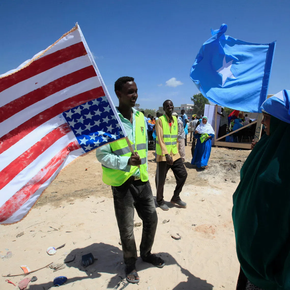 FILE PHOTO: A man holds on to a American flag during a rally welcoming the announcement that the United States has officially recognized Somalia's government, after more than two decades, in Mogadishu, Somalia January 21, 2013. REUTERS/Omar Faruk/File Photo