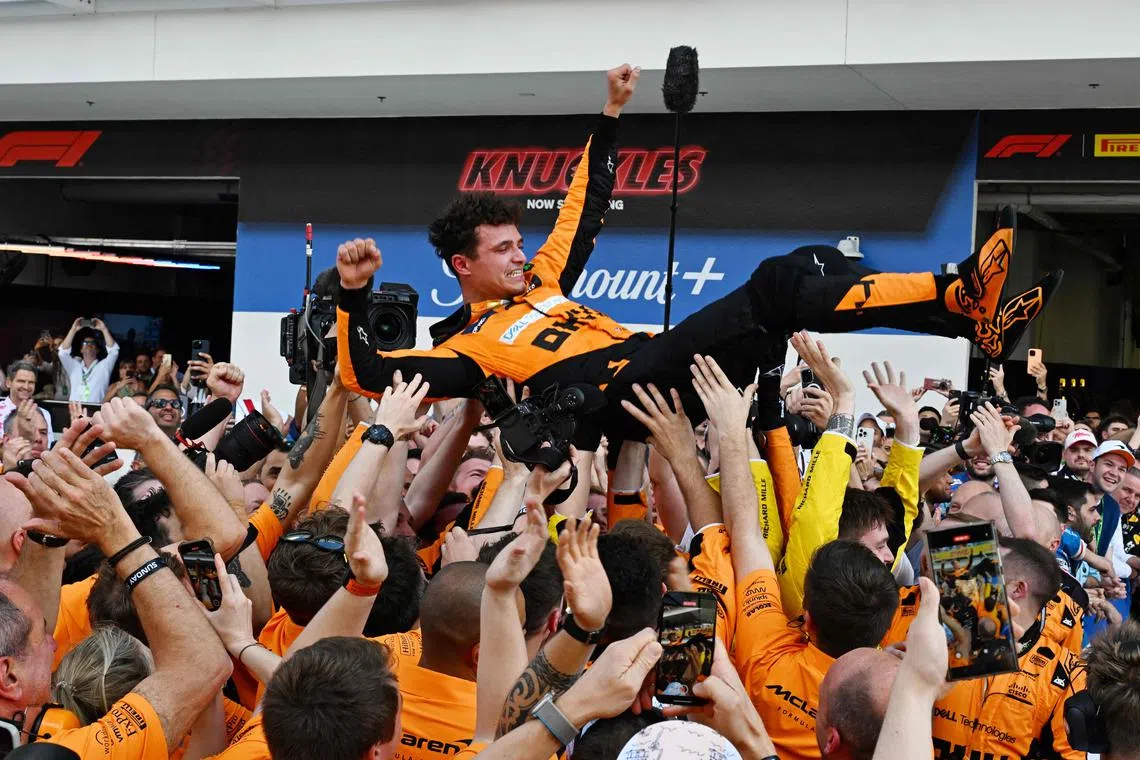 McLaren's Lando Norris is tossed in the air as his team celebrates his victory in the Miami Grand Prix. The Briton has said that he is fully focused on the next race in Imola.