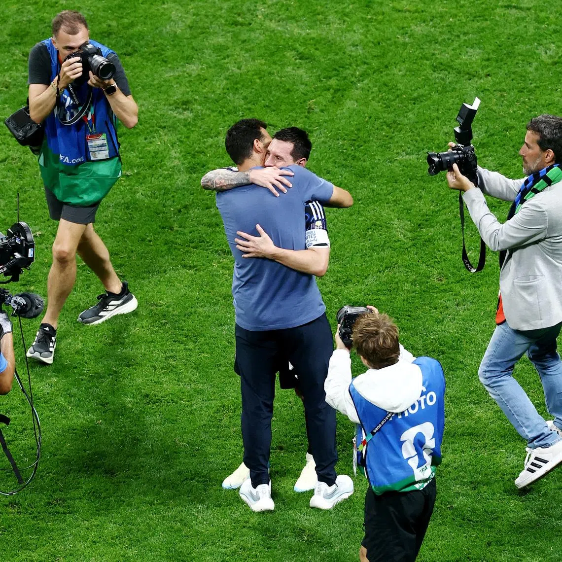 Argentina’s Lionel Messi and coach Lionel Scaloni embrace after Argentina reach the World Cup final.