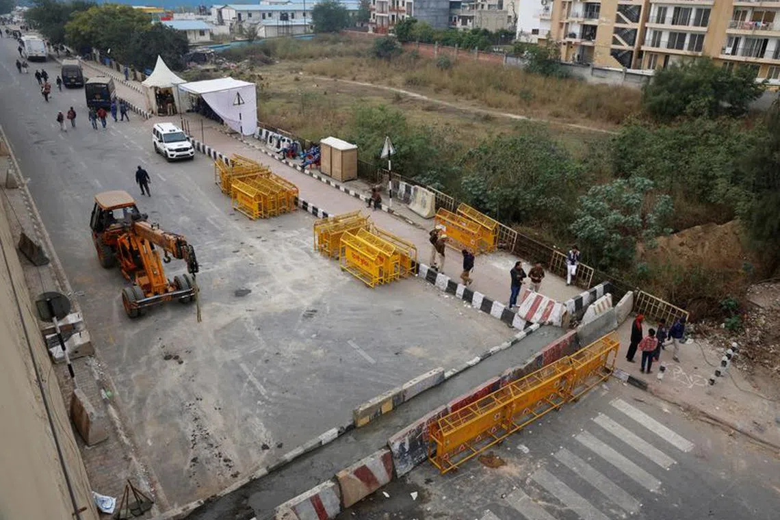 Police barricades are erected on a national highway to stop farmers, who are marching towards New Delhi to press for the better crop prices promised to them in 2021, at the Delhi-Uttar Pradesh border in Ghaziabad, India, February 12, 2024. REUTERS/Adnan Abidi/File Photo