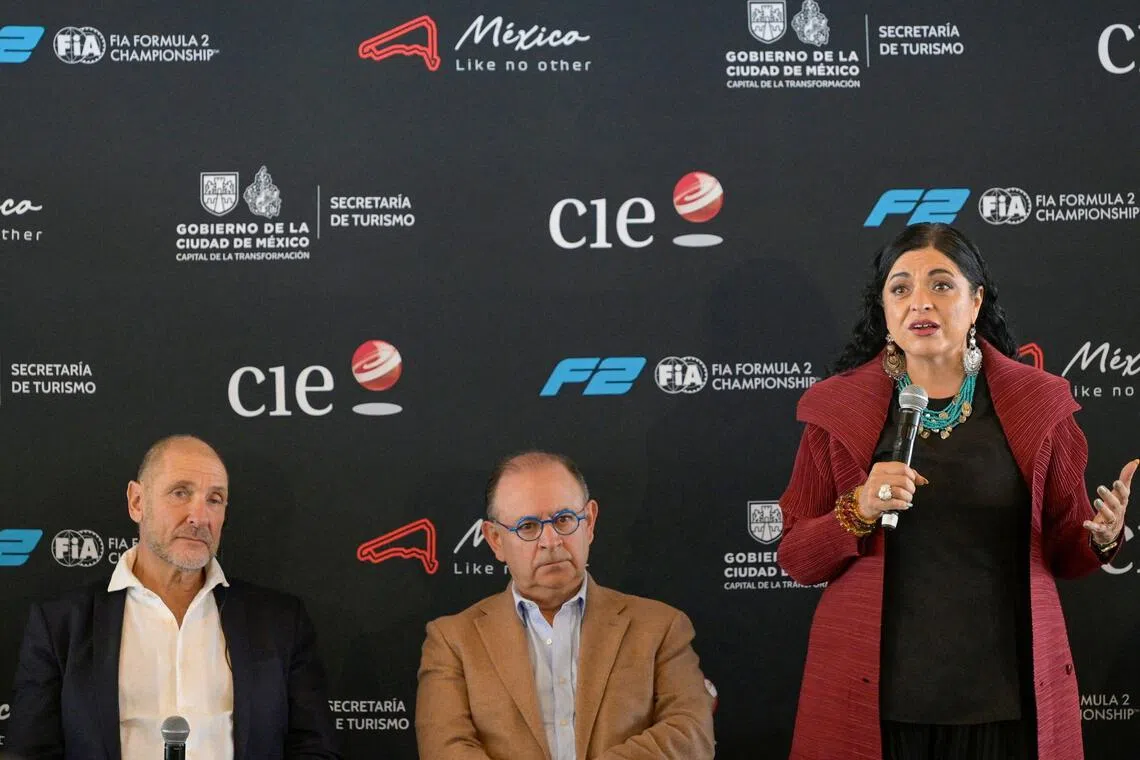 Mexico City Tourism Secretary Alejandra Fraustro (R) speaks alongside Bruno Michel (L), Chief Executive Officer (CEO) of the FIA Formula 2 and Formula 3 Championships, and Federico Gonzalez Compean (C), CEO of the Formula One Mexico City Grand Prix, during the announcement of a Formula 2 race in Mexico City as part of the 2027 calendar at the Autodromo Hermanos Rodriguez in Mexico City on October 5, 2026. (Photo by Alfredo ESTRELLA / AFP)