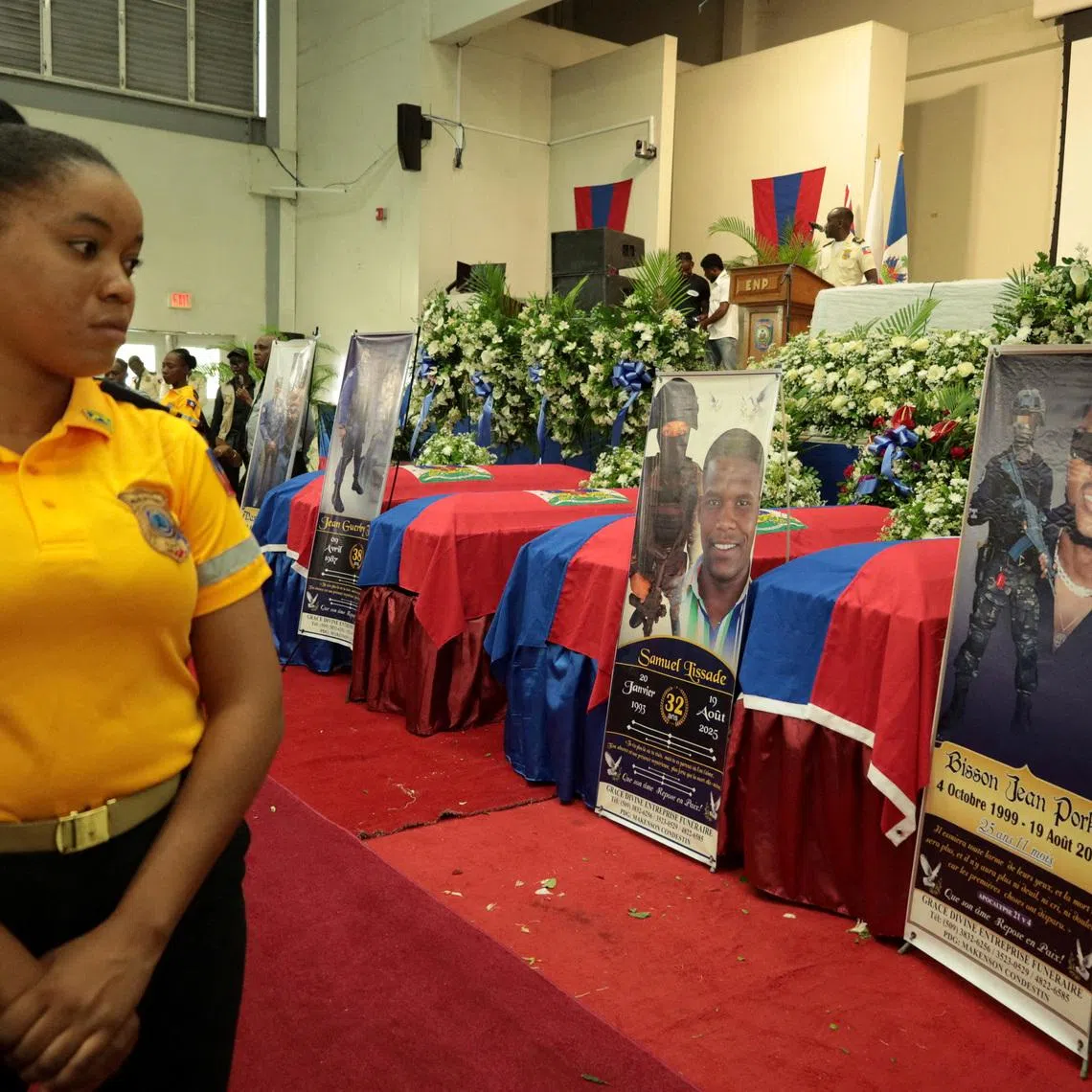 FILE PHOTO: A member of the police attends the funeral of four Haitian police officers, two of whom were killed when an explosive drone accidentally detonated at a SWAT base in August, on the outskirts of Port-au-Prince, in Kenscoff, Haiti, September 6, 2025. REUTERS/Egeder Pq Fildor/File Photo
