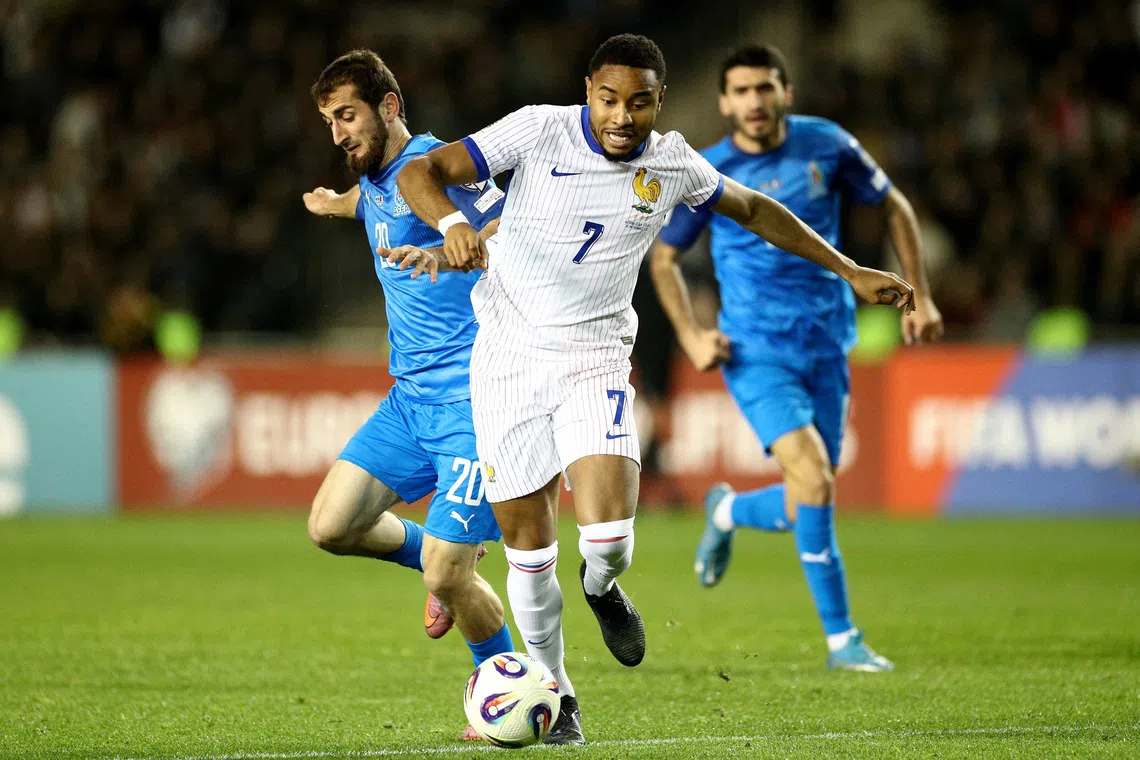 Soccer Football - World Cup - UEFA Qualifiers - Group D - Azerbaijan v France - Tofiq Bahramov Republican Stadium, Baku, Azerbaijan - November 16, 2025 Azerbaijan's Abdulakh Khaybulaev in action with France's Christopher Nkunku REUTERS/Aziz Karimov