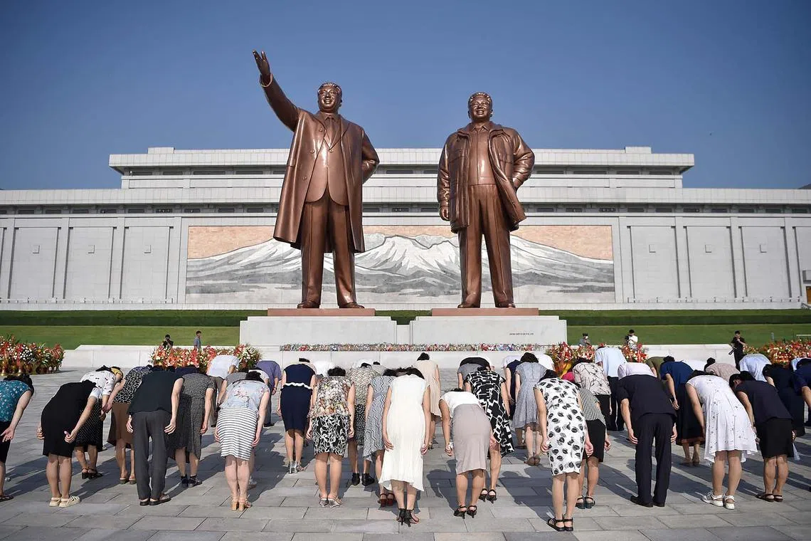 People paying their respects before the statues of late North Korean leaders Kim Il Sung and Kim Jong Il at Mansu Hill as North Korea marks its 79th National Liberation Day, commemorating the end of Japanese colonial rule at the end of World War II, in Pyongyang on Aug 15, 2024.