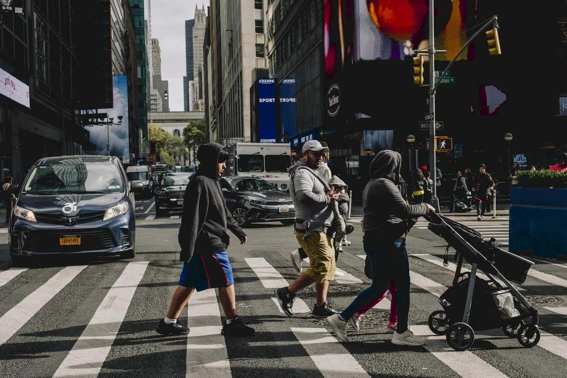 Pedestrians cross the street at the intersection of 41st Street and Seventh Avenue in Manhattan, Oct. 29, 2024. New Yorkers can now cross the street wherever they please. Some fear it could lead to chaos. (Mark Abramson/The New York Times)