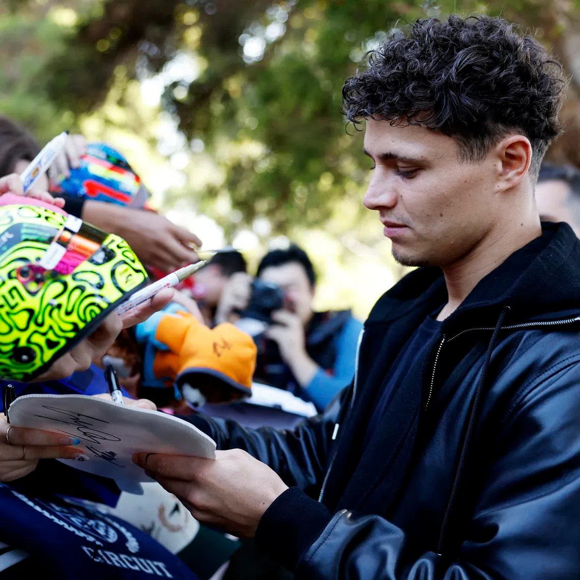 Formula One F1 - Australian Grand Prix - Albert Park Grand Prix Circuit, Melbourne, Australia - March 5, 2026 McLaren's Lando Norris signs autographs for fans ahead of the Australian Grand Prix REUTERS/Hollie Adams