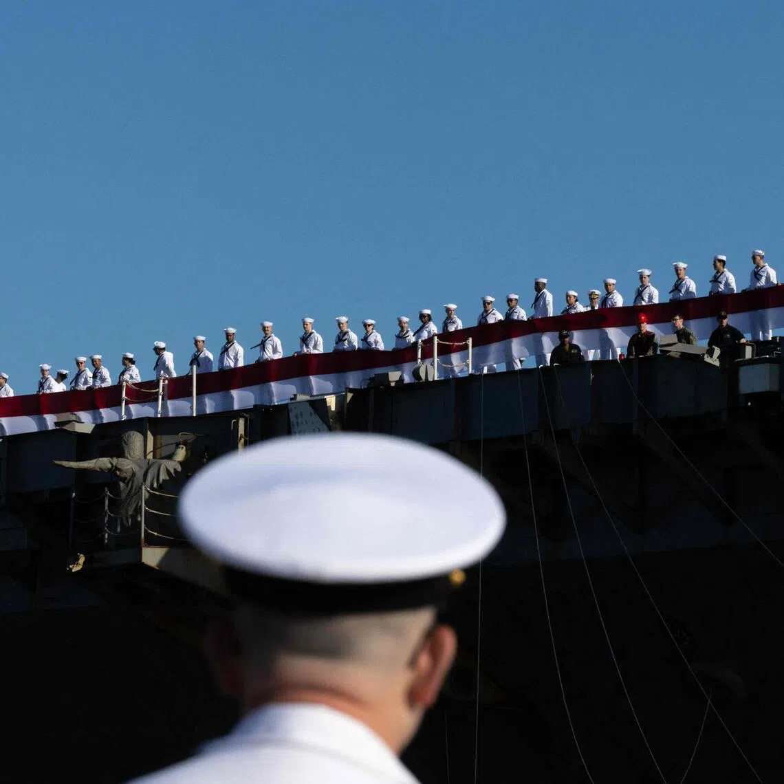 Sailors stand on aircraft carrier USS Gerald R. Ford as it returns to Naval Station Norfolk on May 16 in Norfolk, Virginia. 
